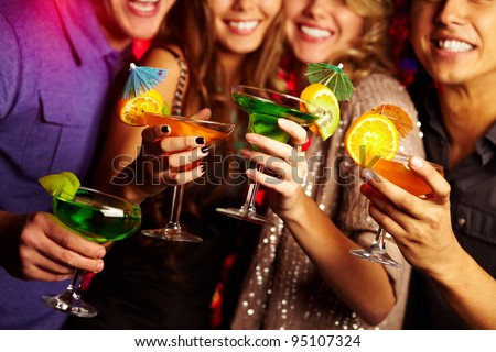 Young people having fun at a birthday party with cocktails