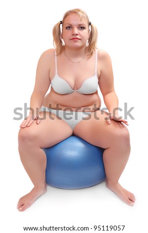 Picture of a overweight woman practising with ball. Health care concept.