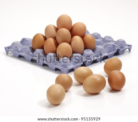 Stack of eggs in tray.