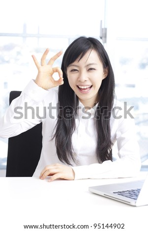 young woman showing OK sign.