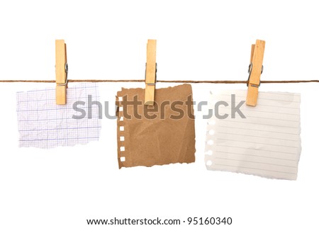close up of a notes and a clothes pegs on white background