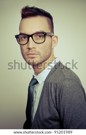 closeup portrait of handsome young adult wearing glasses - colorized old style photo