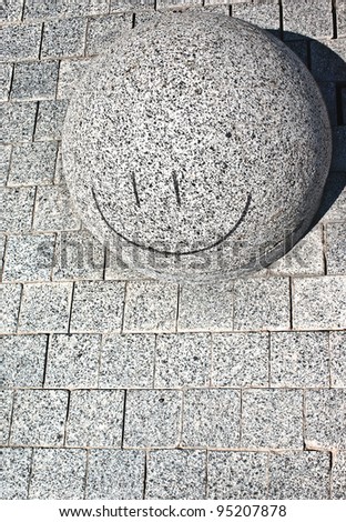 Smiling stone in city street