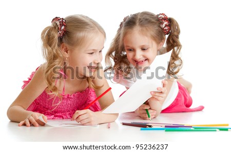 two girls drawing with color pencils together. Focus on the girl on foreground