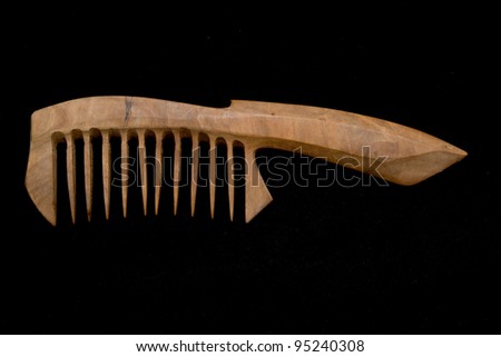 Wooden hairbrush. Isolated on black