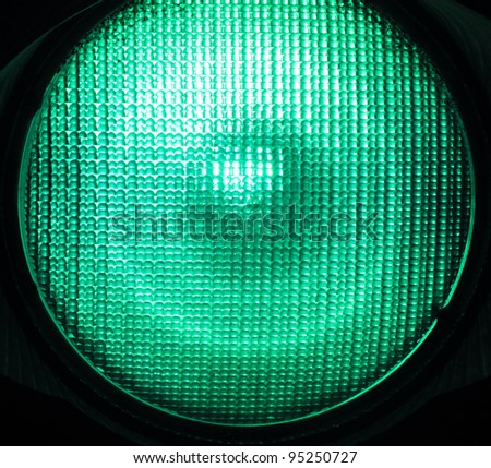 Macro shot of green traffic light illuminated
