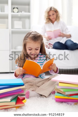 Shaping the habit of reading in kids - teaching by example Royalty-Free Stock Photo #95254819