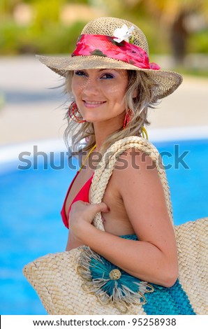 young beautiful woman at the pool in summer
