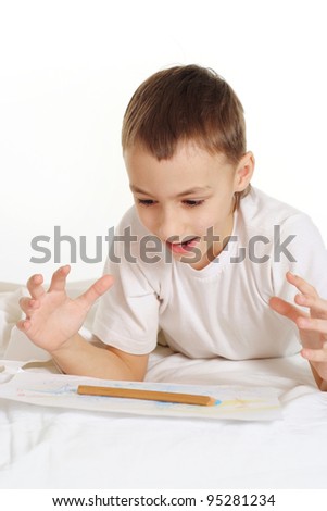 young man on white floor with a pen
