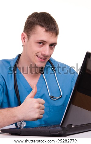 Nice doctor sitting at the laptop on a light