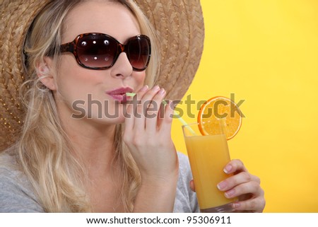 Woman drinking glass orange juice