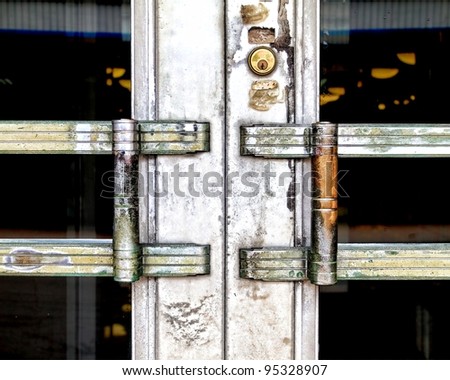 Close-up of an old crunchy looking metal door with handles