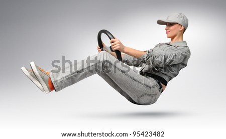 Young girl car driver in cap and jacket with a wheel, concept