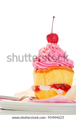 A two layer cupcake with pink and white buttercream and gold powder on a white background as a studio shoot