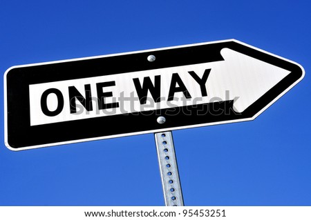 a one way sign over the blue sky