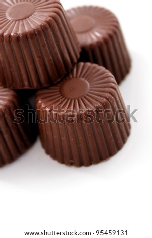 Rounded Chocolates from top corner on white background