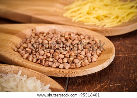 Buckwheat in wooden spoon on wooden table