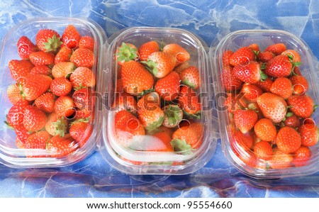 Fresh strawberry in the pack on market.