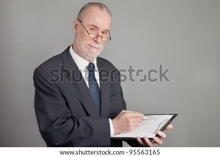 Senior with a checklist on grey background