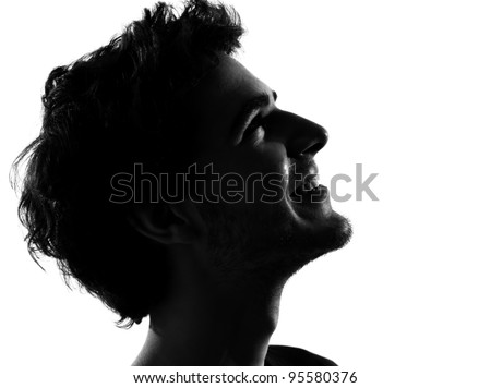 young man looking up portrait silhouette in studio isolated on white background