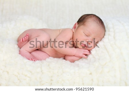 Newborn baby on sheep's wool Royalty-Free Stock Photo #95621590