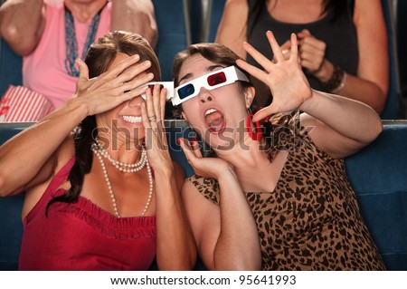 Two amazed women with 3d glasses react to a movie