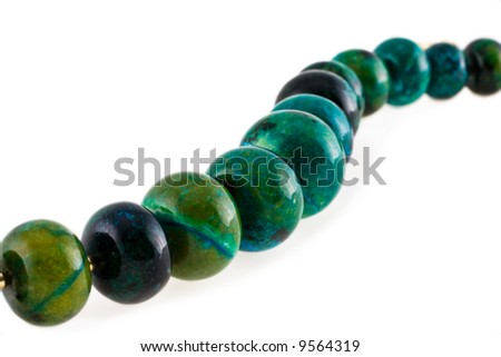 Malachite beads photographed on a white background