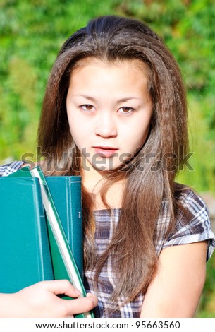 Young  Asian student girl with books