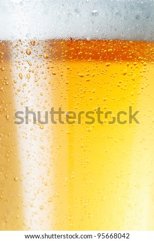 Close-up picture of a condensation on the glass of beer.