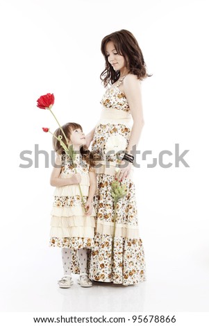 Portrait of mother and little daughter in his arms with a flower
