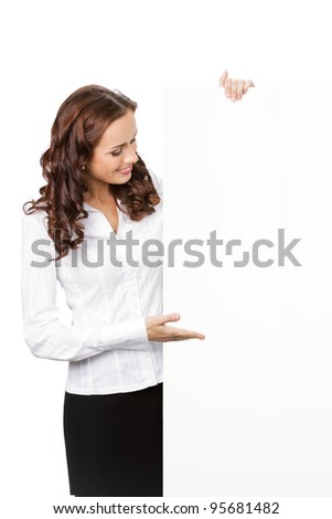 Happy smiling young business woman showing blank signboard, placard or banner, isolated over white background