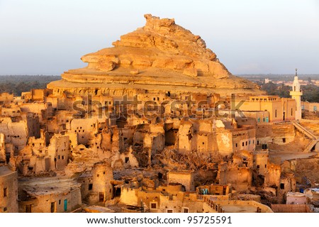 View of the Shali Fortress in Siwa Oasis is an oasis in Egypt, located between the Qattara Depression and the Egyptian Sand Sea in the Libyan Desert. Royalty-Free Stock Photo #95725591