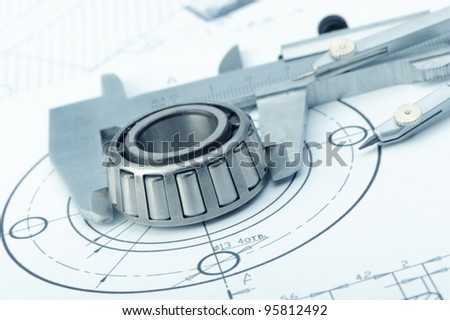 The plan industrial details, a protractor, caliper, divider and bearing. A photo closeup. Blue toning
