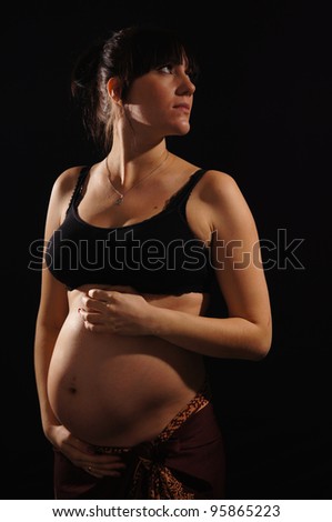 pregnant woman in the top is on a black background