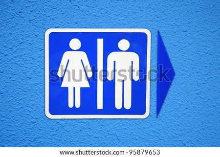 Toilet Sign on blue wall background.