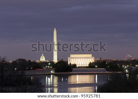 View of Washington DC with Capitol, Washington Monument and Lincoln Memorial, reflection on potomac river, at sunset