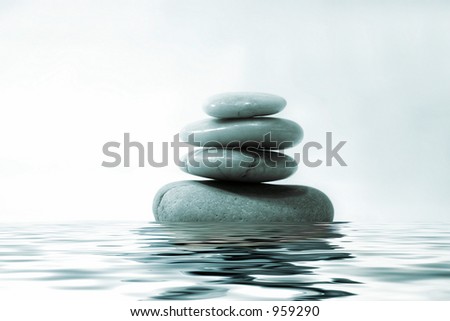 Pebbles stacked with water reflection