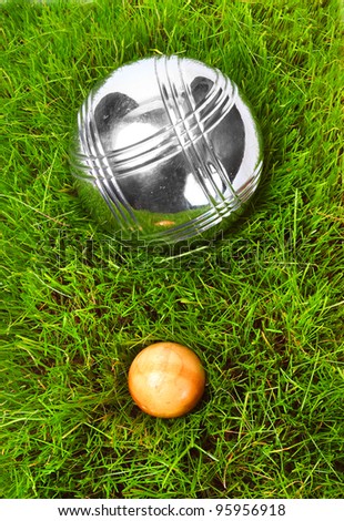 The bocce balls on a green grass. Close up with shallow dof.