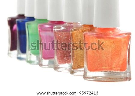 set of nail polish in different colors on white isolated background