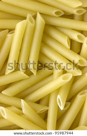 Closeup of uncooked italian pasta - penne macaroni