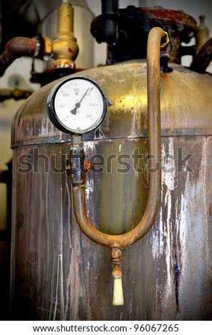 thermometer close-up in old rusty industrial boiler room