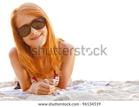 Red-head girl at the beach in sunrise.