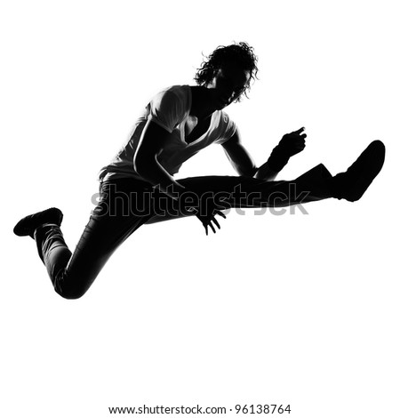 full length silhouette of a young man dancer dancing funky hip hop r&b on  isolated  studio white background