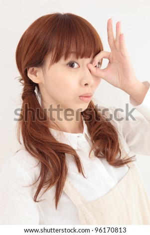 Beautiful young Asian woman wearing a peek apron