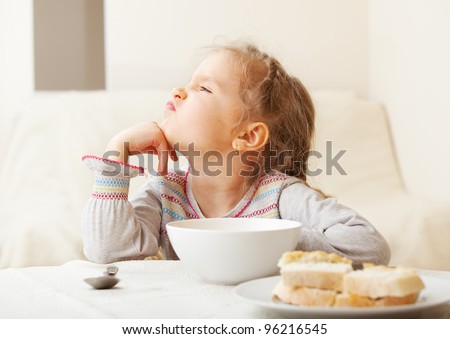 Child looks with disgust for food. Royalty-Free Stock Photo #96216545