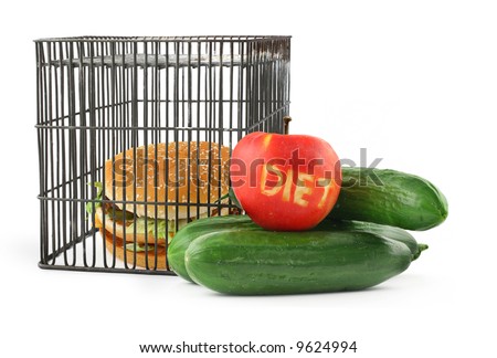 diet concept - fruit, vegetables and fast food behind bars
