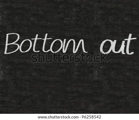 business idioms written on blackboard background, bottom out
