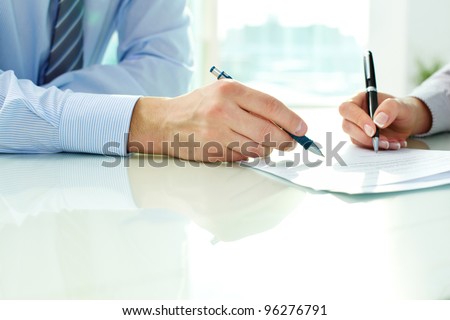 Two business partners signing a document