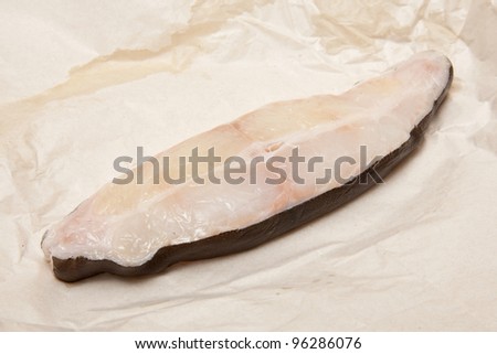 Halibut fish steak isolated on a white studio background.