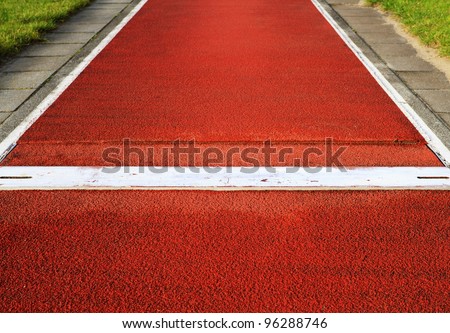Long jump spring plank in an outdoor sports and athletic stadium Royalty-Free Stock Photo #96288746